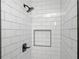 Modern shower with white subway tile surround, a shower head, and a built-in niche for toiletries at 3850 Beya Way, Atlanta, GA 30340