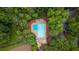 Aerial view of a community pool area surrounded by lush green trees at 4922 Glenside Ct, Stone Mountain, GA 30088