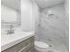 Updated bathroom featuring marble tile, sleek vanity, and shower with mosaic tile at 4922 Glenside Ct, Stone Mountain, GA 30088