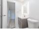 Beautifully renovated bathroom features a gray vanity and a bright mirror in an all-white space at 4922 Glenside Ct, Stone Mountain, GA 30088