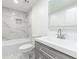 This elegant bathroom features marble-style shower tiles, a modern vanity, and a bright mirror at 4922 Glenside Ct, Stone Mountain, GA 30088