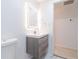 This bathroom features a lighted mirror, a sink, wood cabinets, and access to the hallway at 4922 Glenside Ct, Stone Mountain, GA 30088