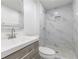 This bathroom features tiled floors and walls, a shower, a sink, and wood cabinets at 4922 Glenside Ct, Stone Mountain, GA 30088