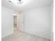 Bedroom with an open door leading to another room, light colored walls, and new flooring at 4922 Glenside Ct, Stone Mountain, GA 30088