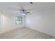 Clean bedroom with light walls, ceiling fan and large window provides natural light at 4922 Glenside Ct, Stone Mountain, GA 30088