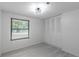 Bedroom featuring closet with louvered doors, new flooring, and a large window at 4922 Glenside Ct, Stone Mountain, GA 30088