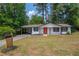 Charming single-story home with a well-maintained lawn, a mailbox and a vibrant red front door at 4922 Glenside Ct, Stone Mountain, GA 30088