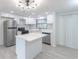 Modern kitchen with stainless steel appliances, marble backsplash, white cabinets, and an island at 4922 Glenside Ct, Stone Mountain, GA 30088