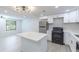 Bright kitchen, island with marble countertop, and view to a living space at 4922 Glenside Ct, Stone Mountain, GA 30088