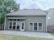 Exterior of the home showcasing several windows and a large concrete patio in backyard at 210 Morning Dove Ln, Suwanee, GA 30024