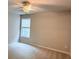 Spacious bedroom with carpet, ceiling fan, and natural light from the window at 210 Morning Dove Ln, Suwanee, GA 30024