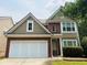 Charming two-story home with a brick and siding exterior and an attached two-car garage at 210 Morning Dove Ln, Suwanee, GA 30024
