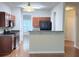 This kitchen features stainless steel appliances, wood cabinets, and a breakfast bar at 210 Morning Dove Ln, Suwanee, GA 30024