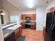 Well-equipped kitchen boasts stainless steel appliances, wooden cabinets, and a breakfast bar at 210 Morning Dove Ln, Suwanee, GA 30024