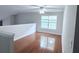 Upstairs loft featuring hardwood floors, ceiling fan, and plenty of natural light from the window at 210 Morning Dove Ln, Suwanee, GA 30024