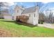 Rear view of the home features a wooden deck and a spacious green lawn at 76 Riverbend Trl, Douglasville, GA 30134