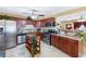 Cherry wood kitchen with granite countertops, stainless steel appliances and an island cart at 76 Riverbend Trl, Douglasville, GA 30134
