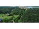 Beautiful aerial view of the property's wooded lot, near a lake at 940 Sandy Ford Rd, Social Circle, GA 30025