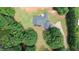 Aerial view showcasing property with a large lawn and lots of trees at 940 Sandy Ford Rd, Social Circle, GA 30025