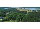 Majestic aerial view showcasing a home bordering a lush forest and lake at 940 Sandy Ford Rd, Social Circle, GA 30025