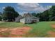 Large backyard featuring a sunroom and a spacious lawn area at 940 Sandy Ford Rd, Social Circle, GA 30025