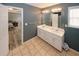 Bathroom featuring a double sink vanity with white cabinets and ceramic tile flooring at 940 Sandy Ford Rd, Social Circle, GA 30025