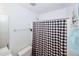 Bright bathroom featuring a shower with a black and white checkered curtain for a modern look at 940 Sandy Ford Rd, Social Circle, GA 30025
