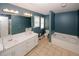 Bathroom with tile floors and features a double sink vanity, bathtub, and separate toilet area at 940 Sandy Ford Rd, Social Circle, GA 30025