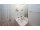 Cozy bathroom with white fixtures, a vanity with a sink, and a decorative mirror at 940 Sandy Ford Rd, Social Circle, GA 30025