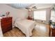Cozy bedroom with unique ceiling fan and hardwood floors at 940 Sandy Ford Rd, Social Circle, GA 30025