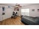 Bedroom with wood-look floors, ceiling fan, and a large window for plenty of natural light at 940 Sandy Ford Rd, Social Circle, GA 30025