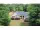 Traditional home with manicured lawn and attractive landscaping at 940 Sandy Ford Rd, Social Circle, GA 30025