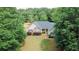 Traditional home with manicured lawn and attractive landscaping at 940 Sandy Ford Rd, Social Circle, GA 30025