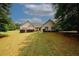 A well-maintained home with a sprawling front yard, complemented by neatly trimmed bushes and charming shutters at 940 Sandy Ford Rd, Social Circle, GA 30025