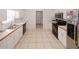 Well-lit kitchen featuring white cabinets, tile flooring and stainless steel appliances, plus lots of counter space at 940 Sandy Ford Rd, Social Circle, GA 30025