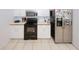Traditional kitchen with white cabinets and stainless steel refrigerator at 940 Sandy Ford Rd, Social Circle, GA 30025