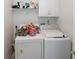 A well-equipped laundry room with appliances and storage space at 940 Sandy Ford Rd, Social Circle, GA 30025