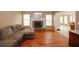 Bright living room featuring a stone fireplace and hardwood floors at 940 Sandy Ford Rd, Social Circle, GA 30025