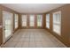 Open living room with neutral colors, tile floors, lots of natural light and a sliding glass door at 940 Sandy Ford Rd, Social Circle, GA 30025