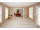 Bright and airy living room featuring tile floors and neutral color palette with an open access to the dining room at 940 Sandy Ford Rd, Social Circle, GA 30025