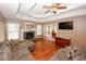 Open living room with fireplace, hardwood floors, and access to dining area at 940 Sandy Ford Rd, Social Circle, GA 30025