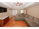 Spacious living room with hardwood floors and a large sectional couch at 940 Sandy Ford Rd, Social Circle, GA 30025