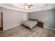 Main bedroom features wood-look floors, ceiling fan, and neutral decor at 940 Sandy Ford Rd, Social Circle, GA 30025