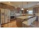 Spacious kitchen with a large island, granite countertops, and stainless steel appliances at 200 Baumgard Way, Locust Grove, GA 30248
