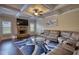 Spacious living room features a stone fireplace, elegant coffered ceilings, and a cozy, oversized sectional sofa at 200 Baumgard Way, Locust Grove, GA 30248