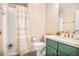Charming bathroom featuring a shower with a striped curtain and green cabinets at 4266 Roswell Ne Rd # L3, Atlanta, GA 30342