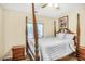 Comfortable bedroom showcasing a four-poster bed, side tables, and a bright window at 4266 Roswell Ne Rd # L3, Atlanta, GA 30342