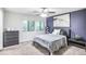 Bedroom featuring a bed, nightstand, dresser, and two large windows at 4266 Roswell Ne Rd # L3, Atlanta, GA 30342
