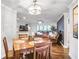 Dining area with a wooden table and chairs, modern lighting, and easy access to the living area at 4266 Roswell Ne Rd # L3, Atlanta, GA 30342
