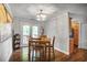 Dining room with a wooden table, modern chandelier, and access to a porch through glass doors at 4266 Roswell Ne Rd # L3, Atlanta, GA 30342